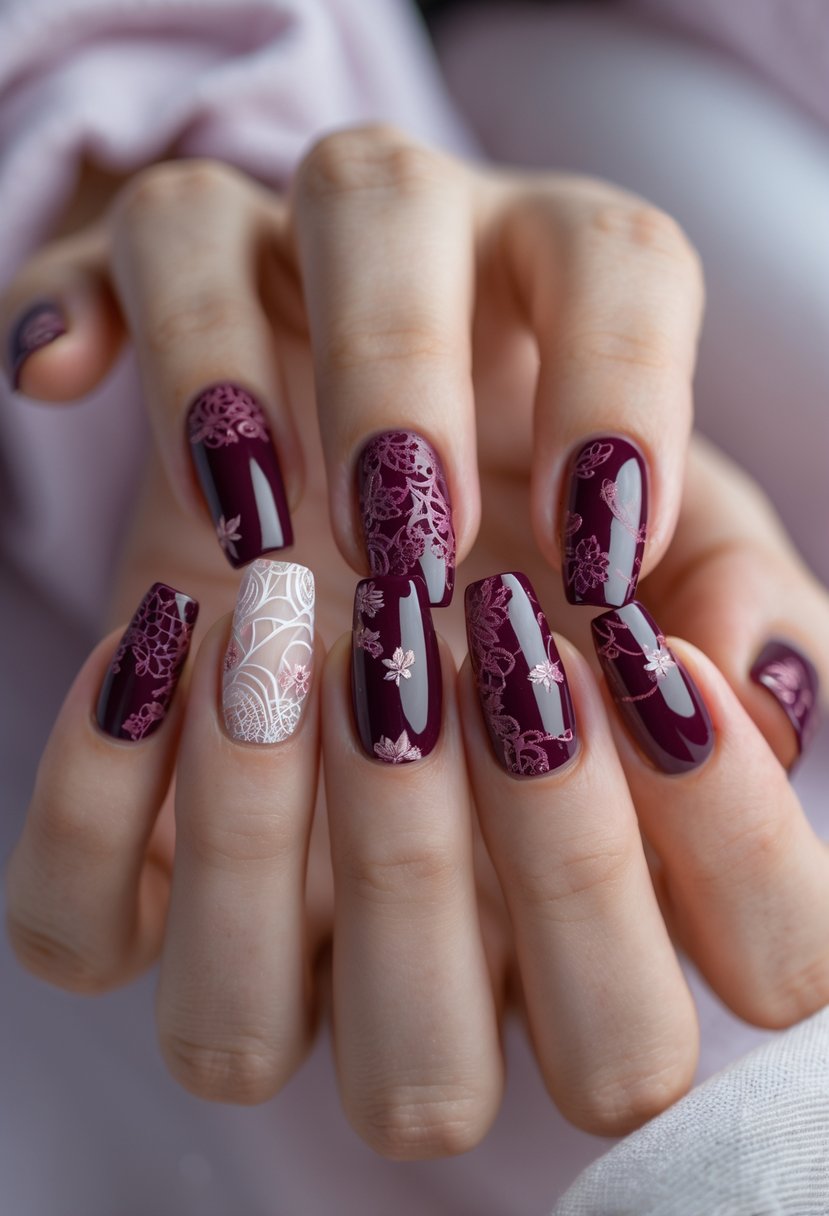 Close-up of a woman's hand showing eight fingernails with detailed burgundy lace nail art designs.