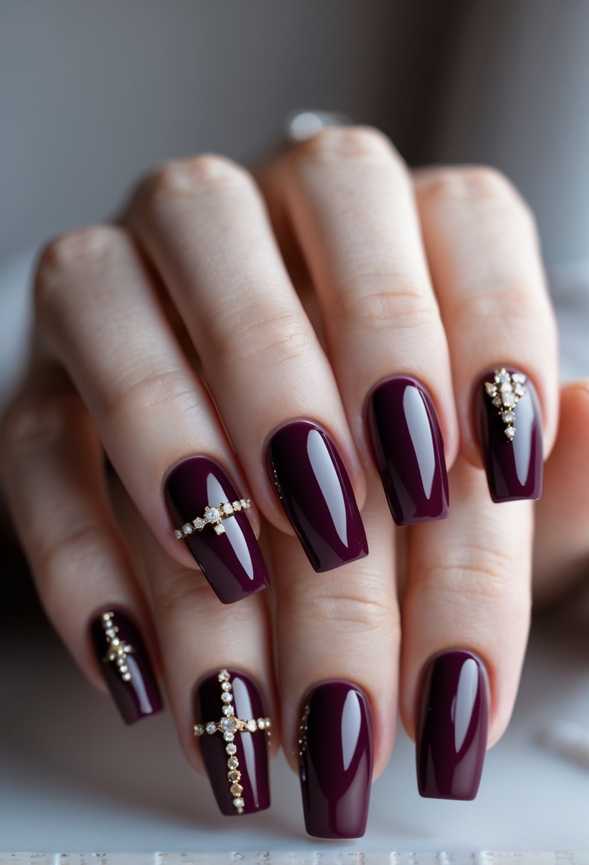 Close-up of a woman's hands showing seven burgundy nails with subtle rhinestone decorations.