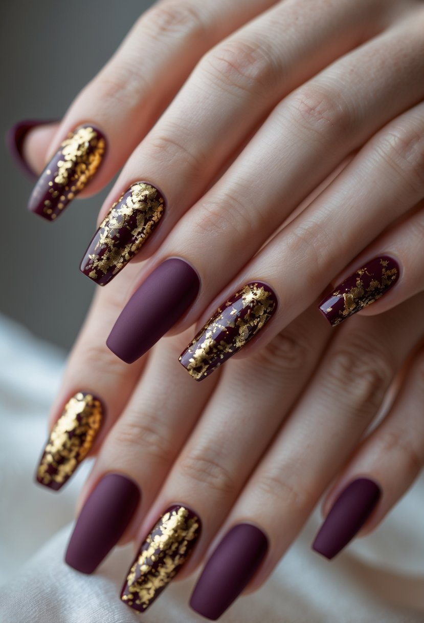 Close-up of five nails painted in matte burgundy with shiny gold flake accents on well-groomed hands.