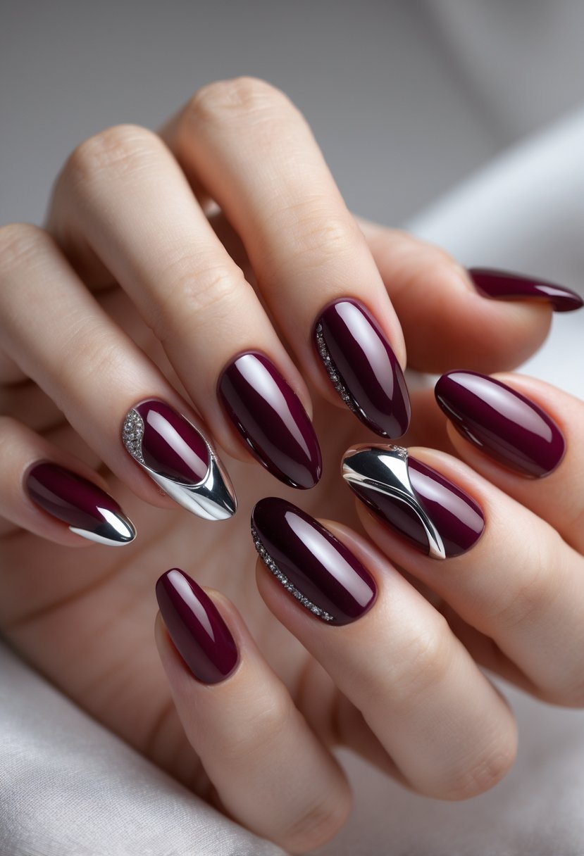 Close-up of a hand with eight maroon and burgundy nails featuring different stylish designs and chrome accents.