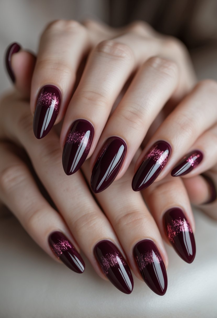 Close-up of a woman's hands showing eight maroon nails with shiny cat eye effect designs.