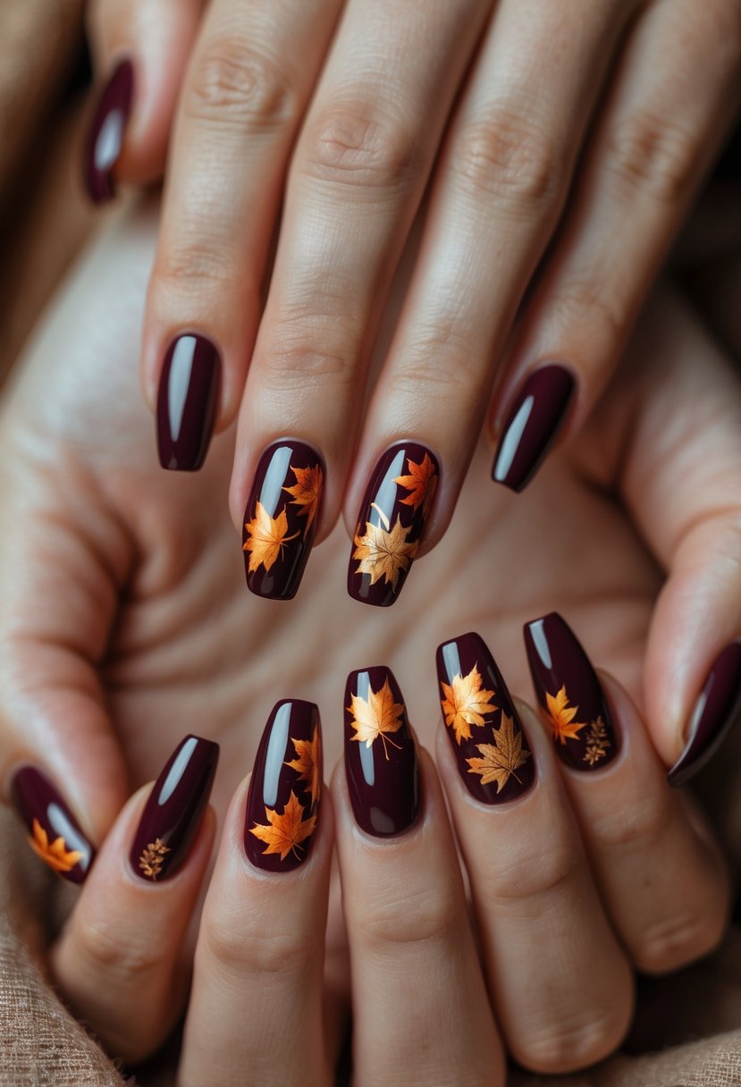 Close-up of six burgundy nails with detailed leaf designs in autumn colors on well-manicured hands.